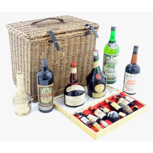 1060 - An old wicker hamper containing assorted fortified wines / spirits / liqueurs, etc. to include Cherr... 