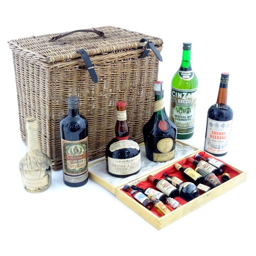 1060 - An old wicker hamper containing assorted fortified wines / spirits / liqueurs, etc. to include Cherr... 