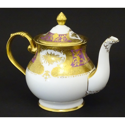 115 - A De Lamerie Fine Bone China teapot in the pattern Royal Bow with gilt highlights. Marked under. Wit... 