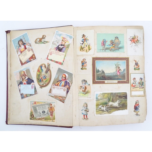 2048 - A Victorian scrapbook / album with applied dog detail to cover, to include various engravings, clipp... 