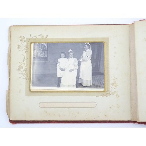 2050 - A late 19thC South African photograph album to include Swazi beehive huts, portraits of nurses, mili... 