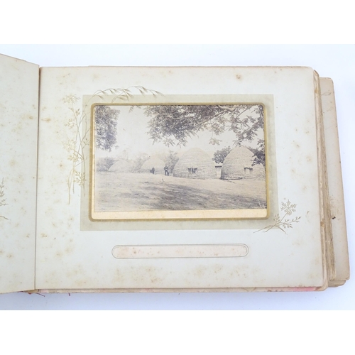 2050 - A late 19thC South African photograph album to include Swazi beehive huts, portraits of nurses, mili... 