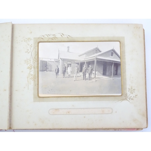 2050 - A late 19thC South African photograph album to include Swazi beehive huts, portraits of nurses, mili... 