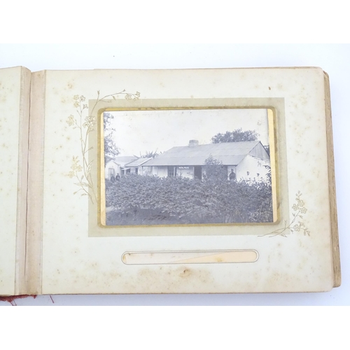 2050 - A late 19thC South African photograph album to include Swazi beehive huts, portraits of nurses, mili... 