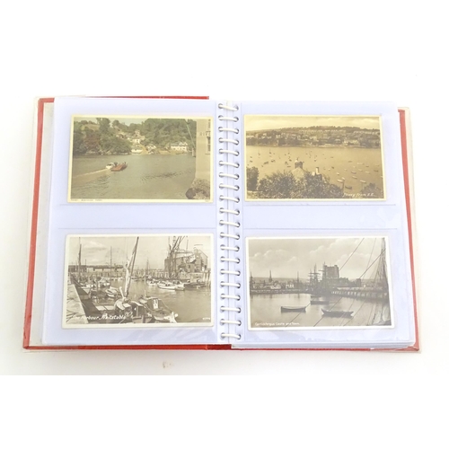 2051 - A 20thC postcard album containing various postcards to include Sandringham Church, the steam ships Q... 