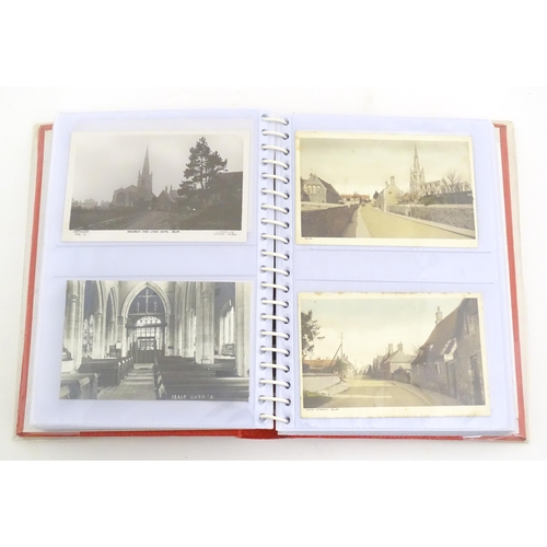 2051 - A 20thC postcard album containing various postcards to include Sandringham Church, the steam ships Q... 