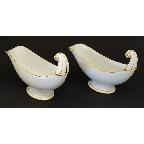 66 - A pair of large French Dore a Sevres sauce boats with scroll handles, decorated with gilt crowned Na... 