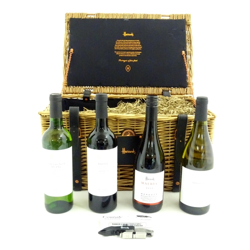 1037 - Wine : A Harrods wicker hamper containing four bottles of Harrods wine and a corkscrew.