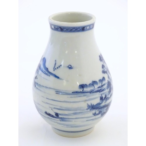 4 - A Chinese blue and white vase decorated with a landscape scene with mountains, pagodas, figures in b... 