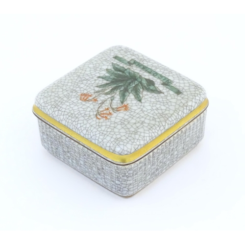 70 - A Royal Copenhagen pot and cover of squared form with a crackle glaze and hand painted Nicotiana flo... 