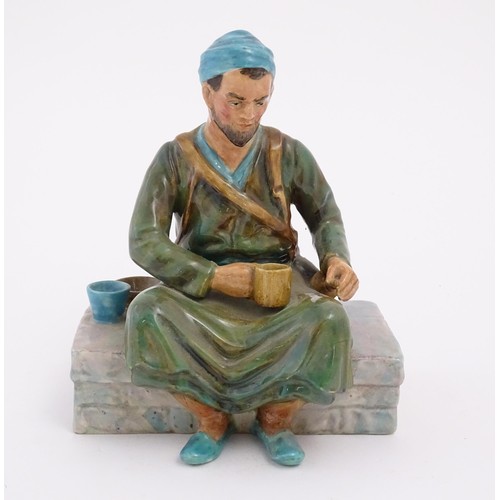 85 - A studio pottery figure modelled as an Egyptian Water Carrier, by Reg Johnson. Signed and titled to ... 