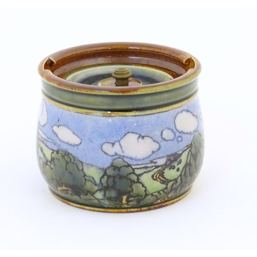 101 - A Royal Doulton stoneware tobacco jar with landscape decoration. Marked under with maker's mark DJ, ... 