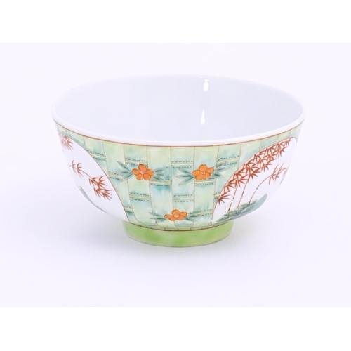 16 - A small Chinese bowl decorated with stylised bamboo and flowers. Character marks under. Approx. 2 1/... 