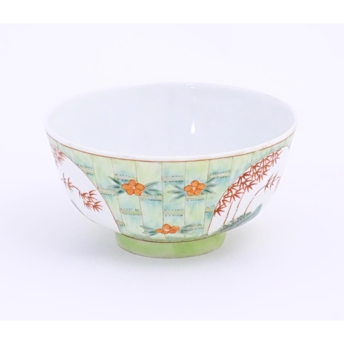 16 - A small Chinese bowl decorated with stylised bamboo and flowers. Character marks under. Approx. 2 1/... 