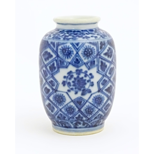 26 - A small Chinese blue and white vase decorated with flowers and foliage in a geometric framework. Cha... 