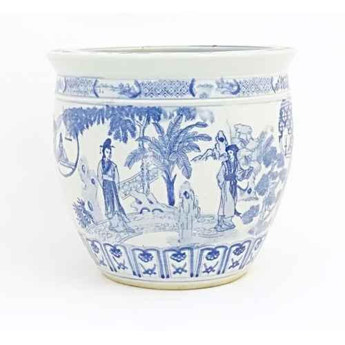 36 - An Oriental style blue and white planter / jardiniere decorated with female figures in a garden land... 
