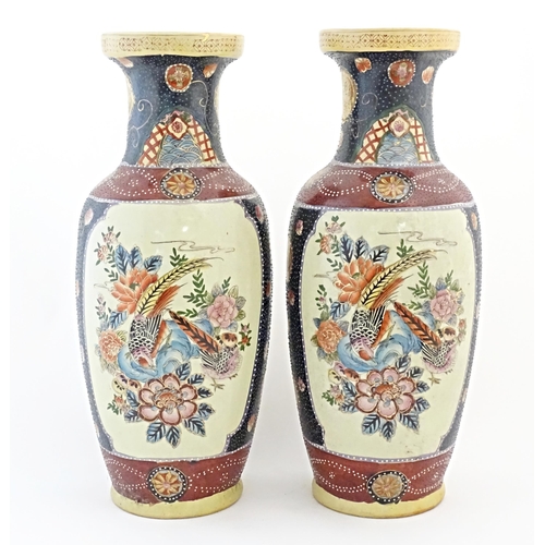48 - A pair of large Oriental vases decorated with panelled decoration depicting birds, flowers and folia... 