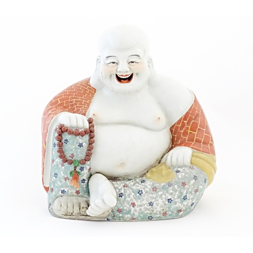 50 - A large Chinese model of a laughing Buddha. Character marks under. Approx. 15
