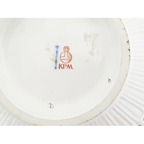 67 - A KPM bowl with a reticulated border, the centre decorated with hand painted flowers. Marked under. ... 