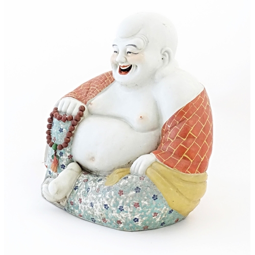 50 - A large Chinese model of a laughing Buddha. Character marks under. Approx. 15