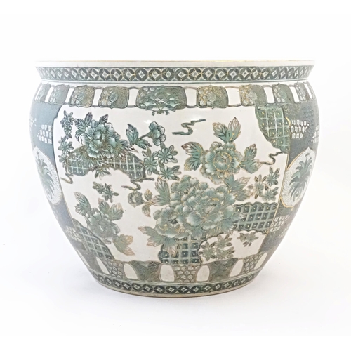 51 - A Chinese famille verte jardiniere / planter decorated with flowers and foliage, with banded borders... 