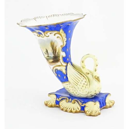 75 - A Victorian vase with swan detail to base, the body decorated with ruins in a landscape and gilt hig... 