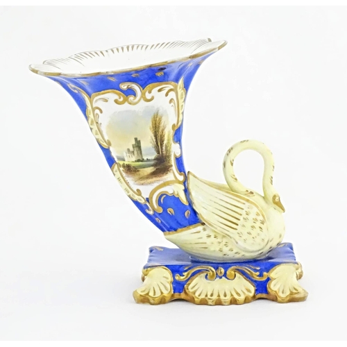 75 - A Victorian vase with swan detail to base, the body decorated with ruins in a landscape and gilt hig... 