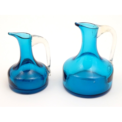 171 - Two Whitefriars glass jugs with turquoise / kingfisher blue bodies and clear glass handles. The tall... 