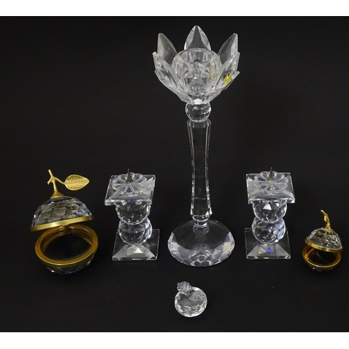 174 - A quantity of Swarovski items to include candlestick, apples, pricket stands etc. Tallest approx 7 3... 