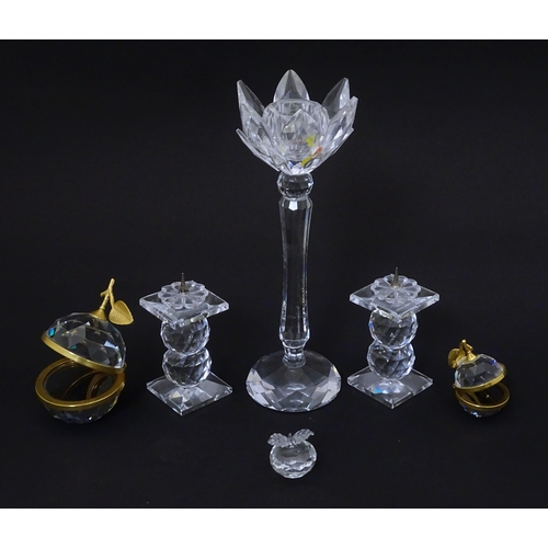 174 - A quantity of Swarovski items to include candlestick, apples, pricket stands etc. Tallest approx 7 3... 