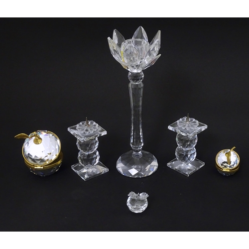 174 - A quantity of Swarovski items to include candlestick, apples, pricket stands etc. Tallest approx 7 3... 