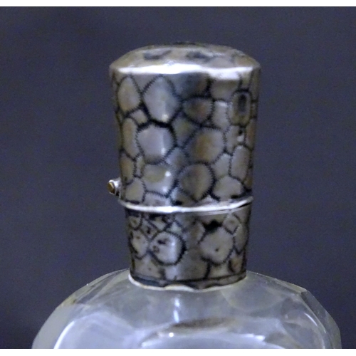 188 - A glass scent / perfume  bottle with Dutch silver top. Approx  3 1/2