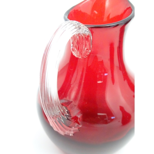 197 - Assorted red glass jugs with clear class handles. To include some Whitefriars examples. The tallest ... 