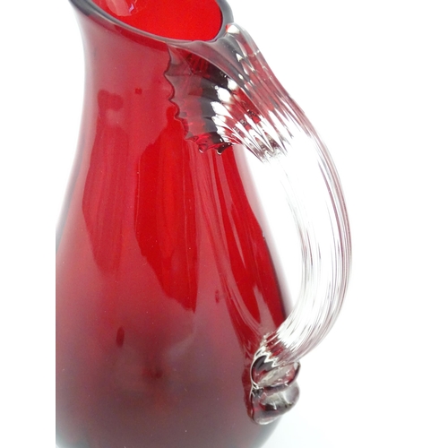 197 - Assorted red glass jugs with clear class handles. To include some Whitefriars examples. The tallest ... 