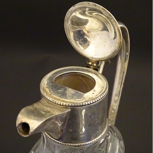 204 - A glass claret jug of ovoid form with silver plate mounts and handle.  Approx. 11 /2