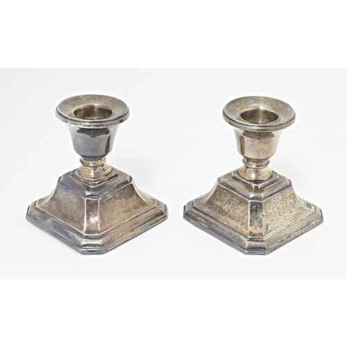 215 - A pair of short silver candlesticks, marked Sterling silver, maker S. M. L. Approx. 3