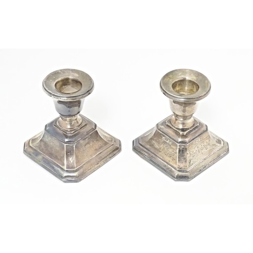 215 - A pair of short silver candlesticks, marked Sterling silver, maker S. M. L. Approx. 3