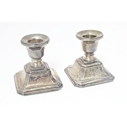 215 - A pair of short silver candlesticks, marked Sterling silver, maker S. M. L. Approx. 3