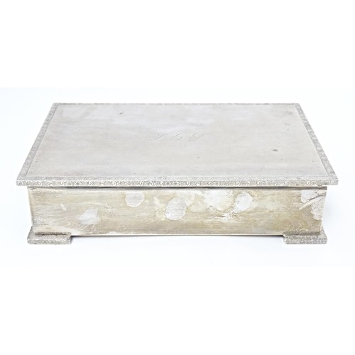 223 - A silver table top cigarette box with wood lined interior, hallmarked Birmingham 1957, maker Garrard... 