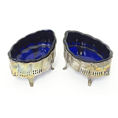 227 - A pair Geo III silver table salts with pierced and engraved decoration, with blue glass liners, hall... 