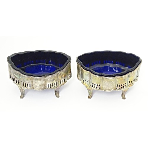 227 - A pair Geo III silver table salts with pierced and engraved decoration, with blue glass liners, hall... 