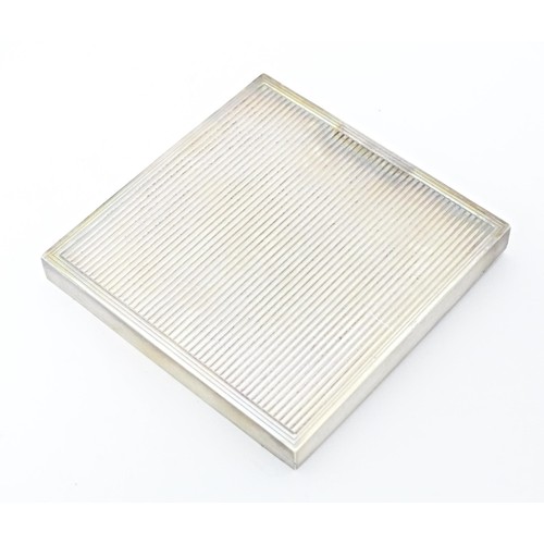 228 - An Art Deco silver compact of square form, hallmarked London 1948, maker David Sutton & Sons. Within... 