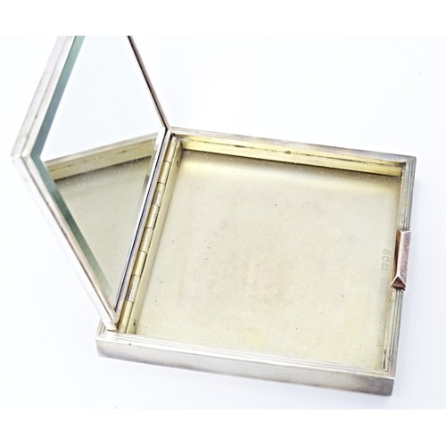 228 - An Art Deco silver compact of square form, hallmarked London 1948, maker David Sutton & Sons. Within... 