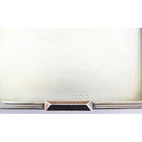 228 - An Art Deco silver compact of square form, hallmarked London 1948, maker David Sutton & Sons. Within... 