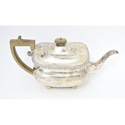 238 - A silver teapot on four squat bun feet, hallmarked London 1911, maker Harrods Stores Ltd. Approx. 11... 