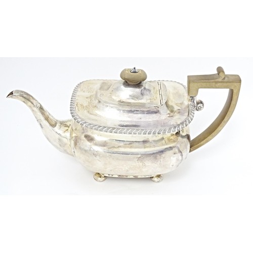 238 - A silver teapot on four squat bun feet, hallmarked London 1911, maker Harrods Stores Ltd. Approx. 11... 