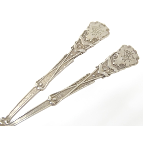 451 - A pair of silver spoons decorated with golf clubs, golf balls, etc. hallmarked Sheffield 1931,
maker... 