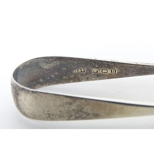 452 - A silver preserve spoon hallmarked Sheffield 1959, maker Viner' Ltd. Together with silver sugar tong... 