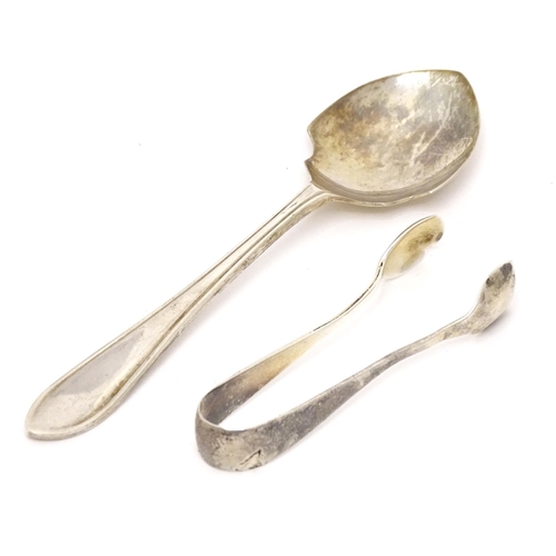 452 - A silver preserve spoon hallmarked Sheffield 1959, maker Viner' Ltd. Together with silver sugar tong... 