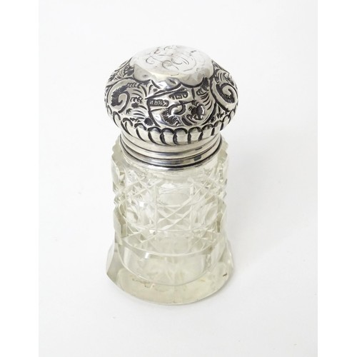 458 - A cut glass salts jar with silver lid, hallmarked London 1906, maker M. Bros. Approx. 3 1/2